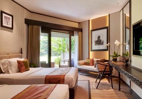 Voodi või voodid majutusasutuse The Singhasari Resort Batu toas