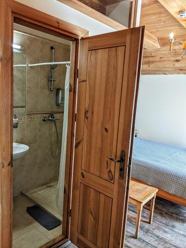 a bathroom with a shower and a glass door at Guest House Kamara in Panevėžys