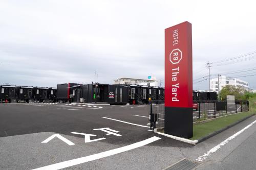 a parking lot with a sign in the middle at HOTEL R9 The Yard Yamaguchiajisu in Azisu