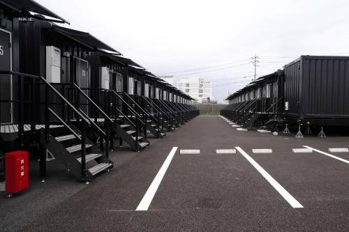 a row of train cars parked in a parking lot at HOTEL R9 The Yard Yamaguchiajisu in Azisu
