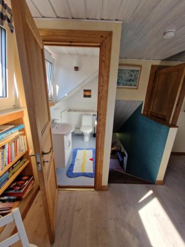 a small bathroom with a toilet and a staircase at Boende på SydKoster med havsutsikt och nära till bryggor in Strömstad