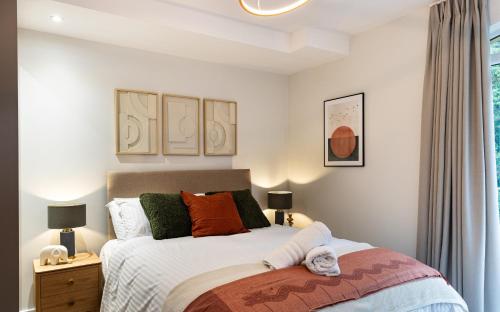 a bedroom with a bed and two lamps and a window at Rock Mill 1 Bed Apartment 4 in Stoney Middleton