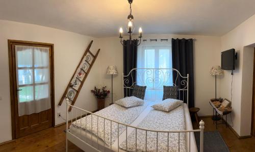 a bedroom with a metal bed and a window at La Novaci Porumbacu de Sus 270 in Porumbacu de Sus
