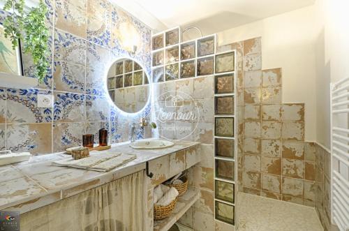 a bathroom with a sink and a mirror at Chez Grand-Mère Cozy Retro Apartment in the Heart of Metz in Metz
