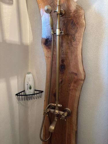 a wooden guitar is leaning against a wall at La Novaci Porumbacu de Sus 270 in Porumbacu de Sus