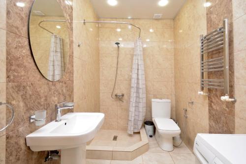 a bathroom with a sink and a toilet and a mirror at Stylish 3 room ap near republic square in Yerevan