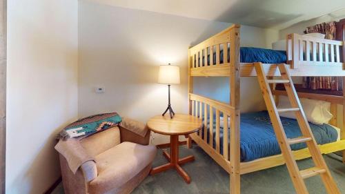 a small room with a bunk bed and a chair at Sunrise - W Glade K-5 in Killington