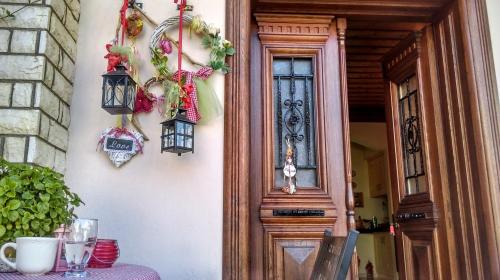 a front door of a house with a table and a table sidx sidx at Valentini Guesthouse in Karpenision