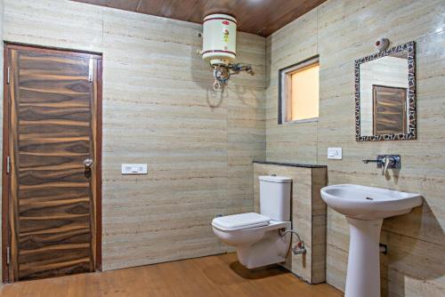 a bathroom with a toilet and a sink at The Western Heights I Serviced Apartments I Pvt Balcony I Lift I Peacefull Area I Family Accomodation I Kasauli By Exotic Stays in Kasauli