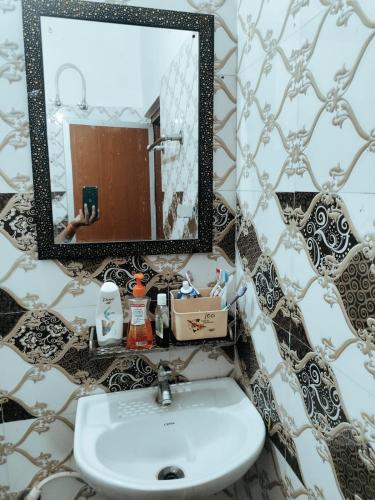 a bathroom with a sink and a mirror at Syno in Lucknow