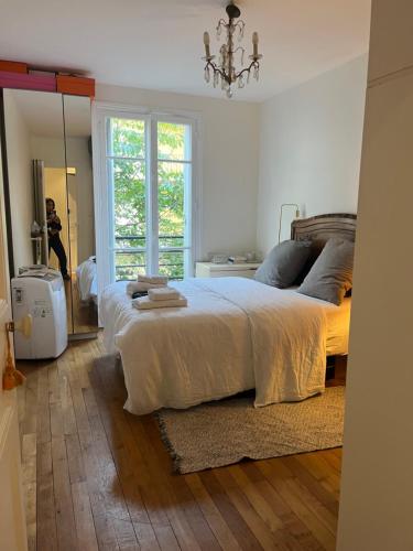 a bedroom with a large bed and a mirror at Bedroom in Paris in Paris