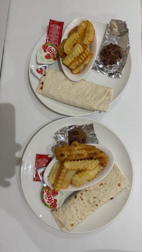 two plates of food on a white table at RAFiF Pyramids View Hotel in Cairo