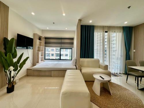 a living room with a bed and a couch at Shi House -Cozy 2BR, S1001 Beautiful Vinhomes Q9 in Ho Chi Minh City