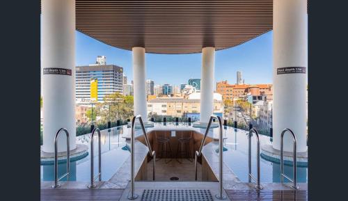 a room with a balcony with a view of the city at Fortitude Valley Dreamscape in Brisbane
