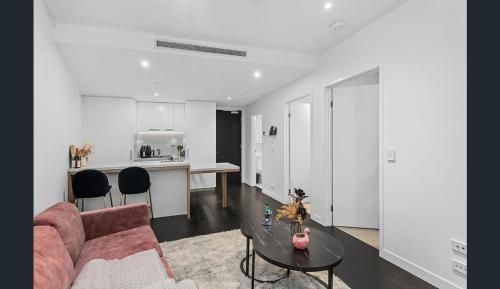 a living room with a couch and a table at Fortitude Valley Dreamscape in Brisbane