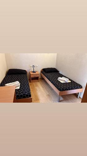 a room with two beds and a table at Guesthouse David i Spoma in Međugorje