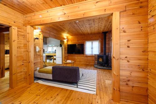 a log cabin with a bed and a fireplace at The Lodge Teshikaga in Teshikaga