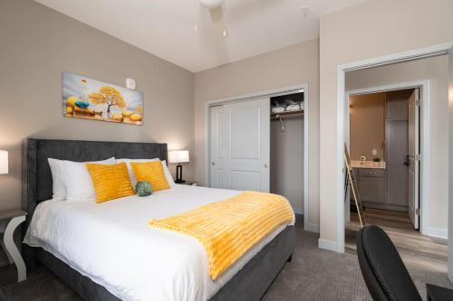 a bedroom with a large bed with orange pillows at Lux Haven Whitestown in Whitestown