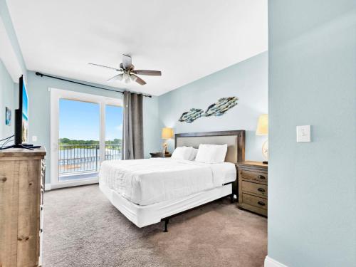 a bedroom with a white bed and a window at Laketown Wharf 331 in Panama City Beach