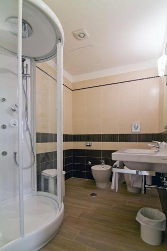 a bathroom with a shower and a sink and a toilet at Galileo B&B in Rende