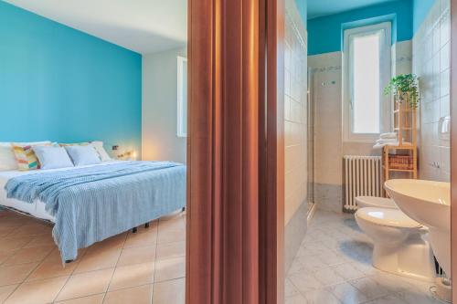 マンデッロ・デル・ラーリオにあるLa Casa sul Fiumeのベッドのある寝室と洗面台のある浴室