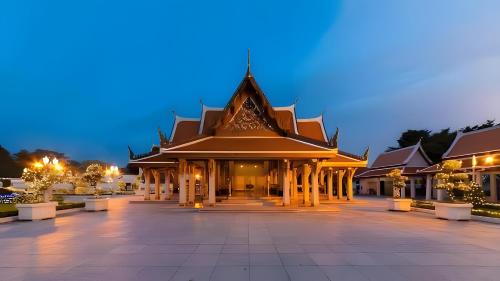 a building with a lit up courtyard at night at xxThe Hidden Giant Swing เดอะ ฮิดเด้น เสาชิงช้า in Bangkok