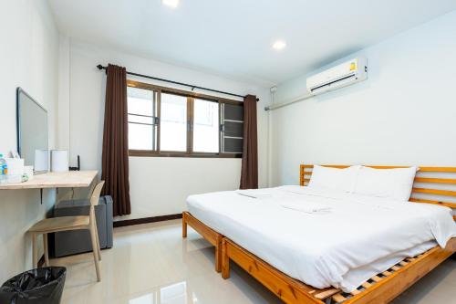 a bedroom with a bed and a desk and a window at xxThe Hidden Giant Swing เดอะ ฮิดเด้น เสาชิงช้า in Bangkok