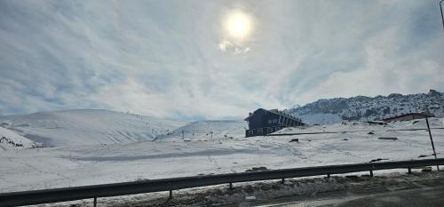 een huis bovenop een met sneeuw bedekte heuvel bij Kaf Mount Erciyes in Hacılar