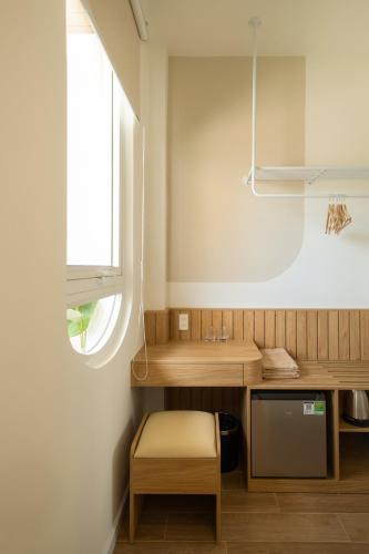 a kitchen with a wooden counter and a window at Venice Home Serenity in Phan Thiet
