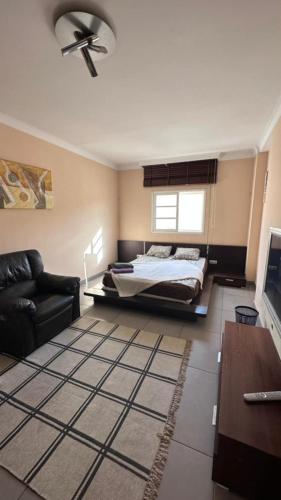 a living room with a bed and a couch at "Flora B&B "- Rooms in Privat Home Habitaciones en una casa privada in Maspalomas