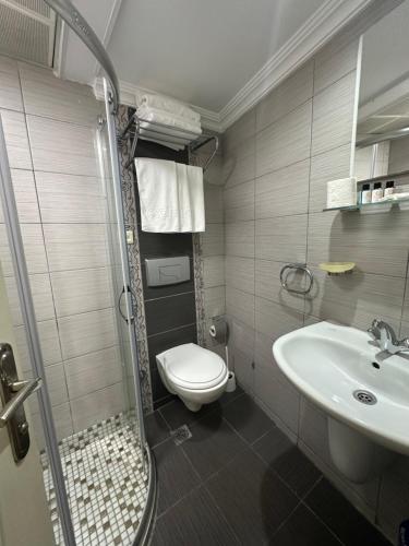 a bathroom with a toilet and a sink at Hotel Süreyya in Istanbul