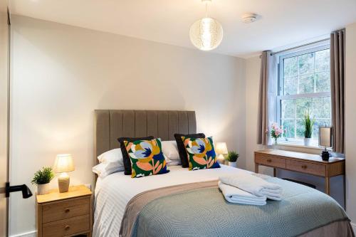 a bedroom with a large bed and a window at Rock Mill 1 Bed Apartment 32 in Stoney Middleton