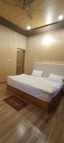 a bedroom with a large bed in a room at Harshvan resort in Chakrāta