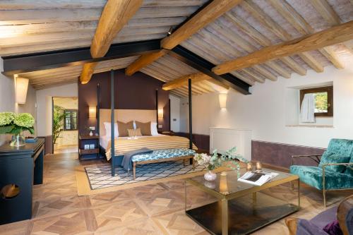 a bedroom with a bed and a living room at Fattoria di Vegi in Castellina in Chianti