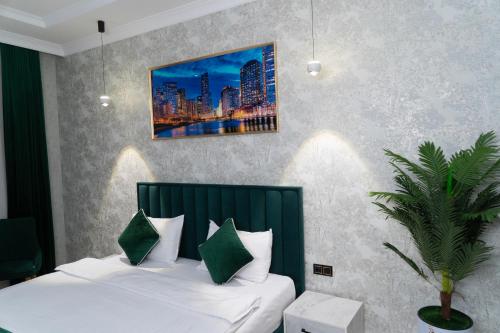 a bedroom with a bed and a painting on the wall at Afruza Hotel in Samarkand