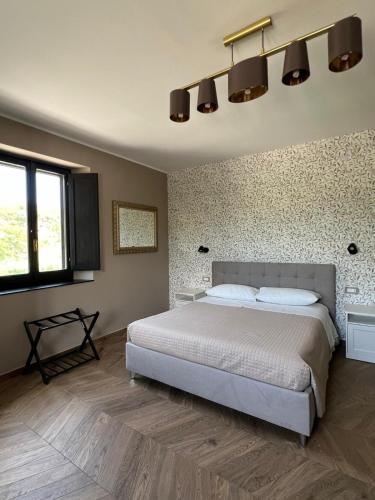 a bedroom with a large bed and a wall at Casale Corneli in Silvi Paese