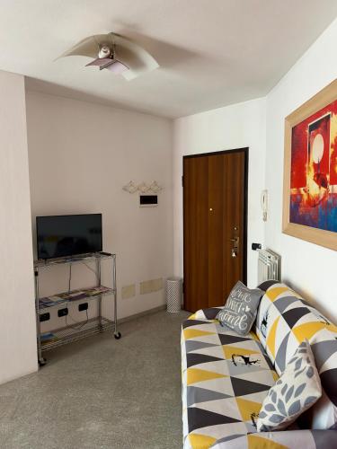 a living room with a couch and a flat screen tv at Morbegno House in Morbegno