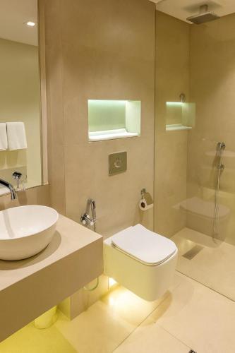 a bathroom with a sink and a toilet and a shower at Unique Suites in Riyadh