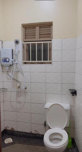 a bathroom with a toilet and a window at Moods Holiday Homes in Kampala