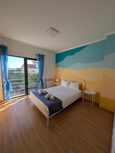 a bedroom with a bed and a large window at The Lookout in Areia Branca