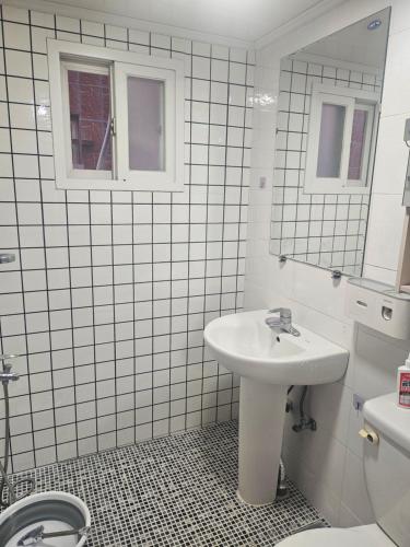 a white bathroom with a sink and a toilet at k조이스테이 in Pongsan-dong