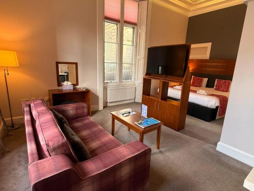 a living room with a couch and a bed at Court Residence Aparthotel in Linlithgow