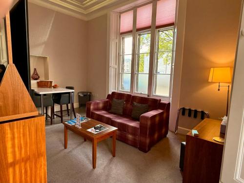 a living room with a couch and a table at Court Residence Aparthotel in Linlithgow
