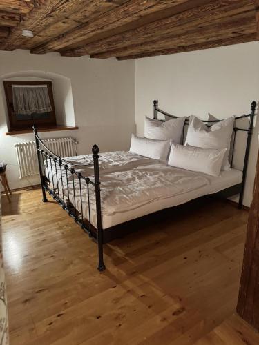 a bedroom with a bed with white pillows at Fürstentor Greding in Greding