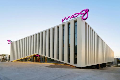 a building with a sign on top of it at Moxy Alfragide Lisboa in Alfragide