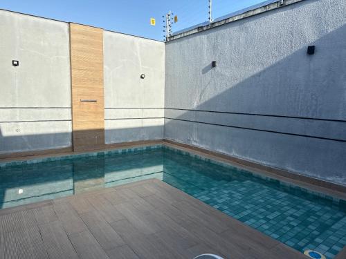a swimming pool with water in a building at Casa Confort Belém in Belém