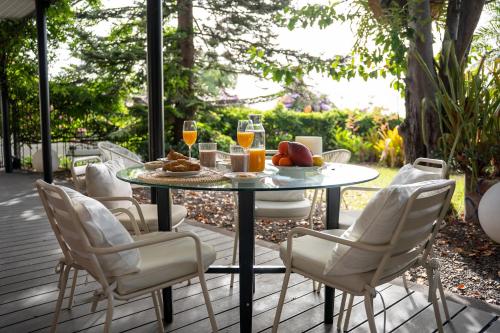 a table and chairs on a patio with glasses of wine at Villa Wisteria in Funchal