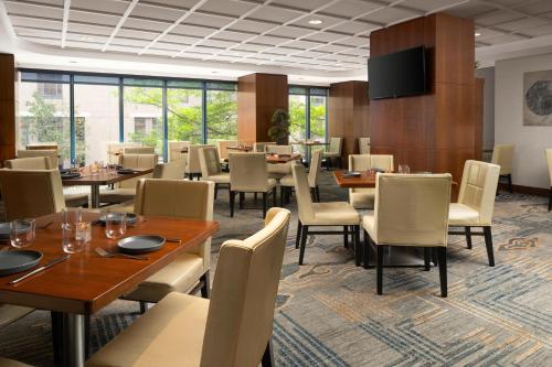 a dining room with tables and chairs and windows at DoubleTree by Hilton Hotel Boston - Downtown in Boston