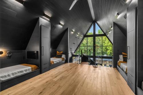 una camera da letto con due letti e una grande finestra di Midnight Raven Lake House - luxury a-frame w boat a Reed Creek