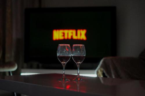two wine glasses sitting on a table in front of a fireplace at Modern 2-Bed House Free Parking Contractors & Families Friendly Rotherham in Park Gate